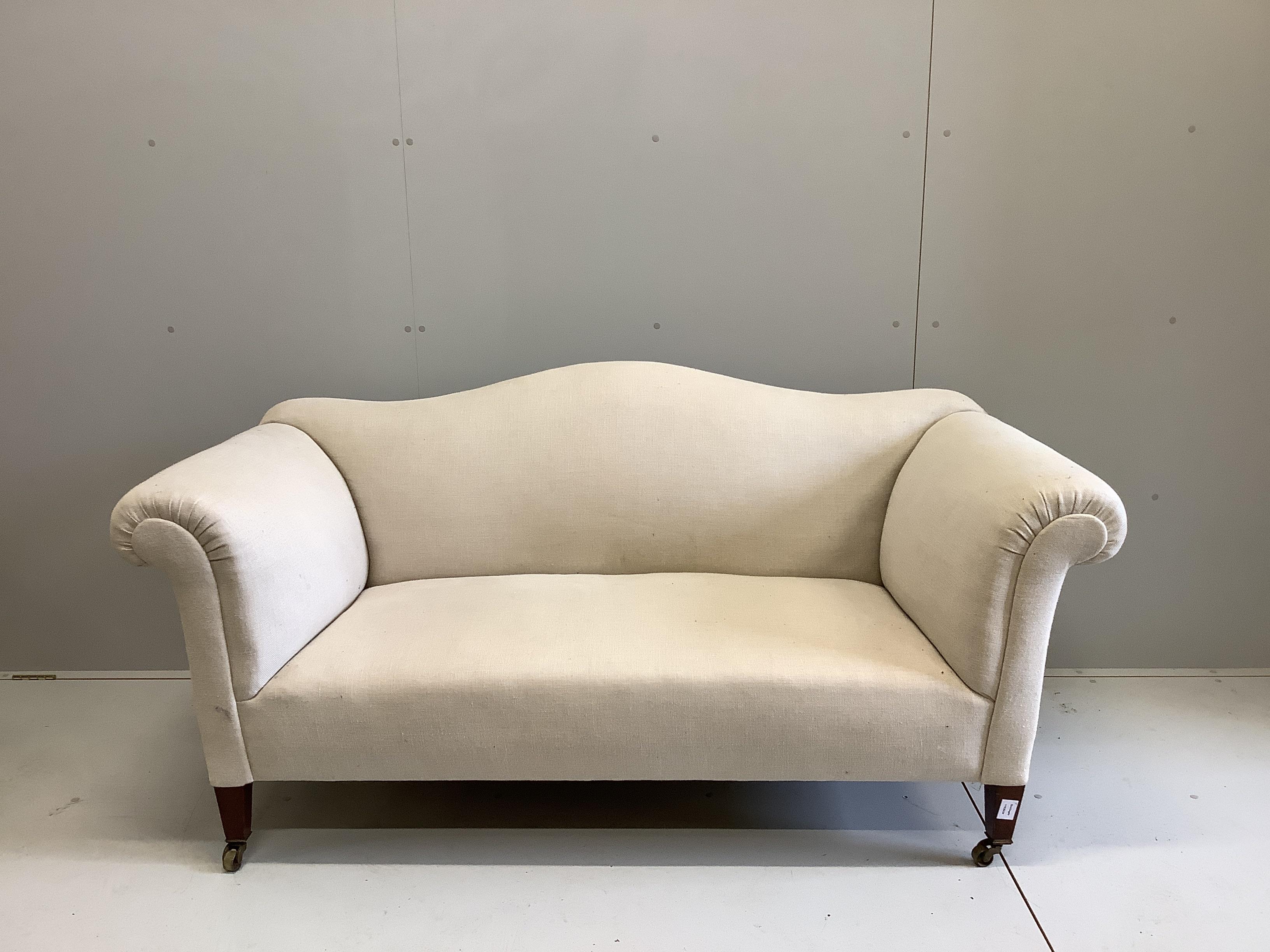 An Edwardian scroll arm settee, recently re-upholstered in a natural colour fabric, width 170cm, depth 80cm, height 72cm